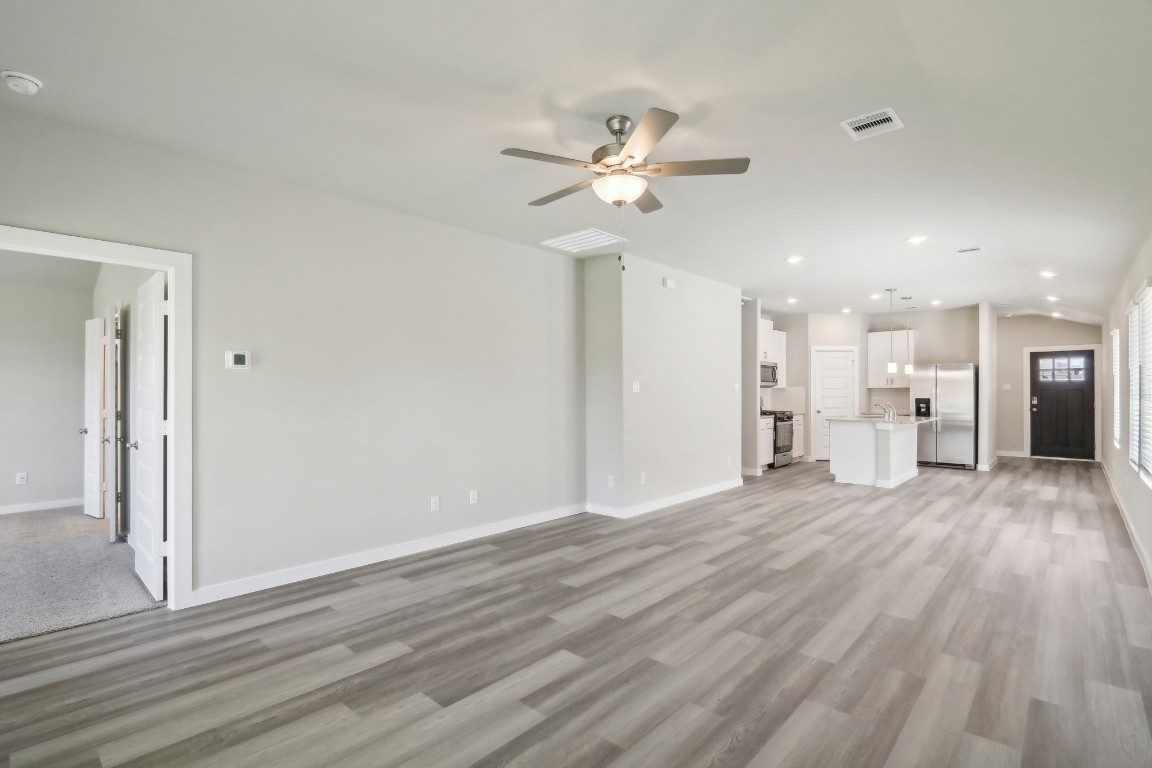 14174 Granger Pointe Lane Conroe, TX 77302 - Photo 4 of 9 a view of an empty room with wooden floor