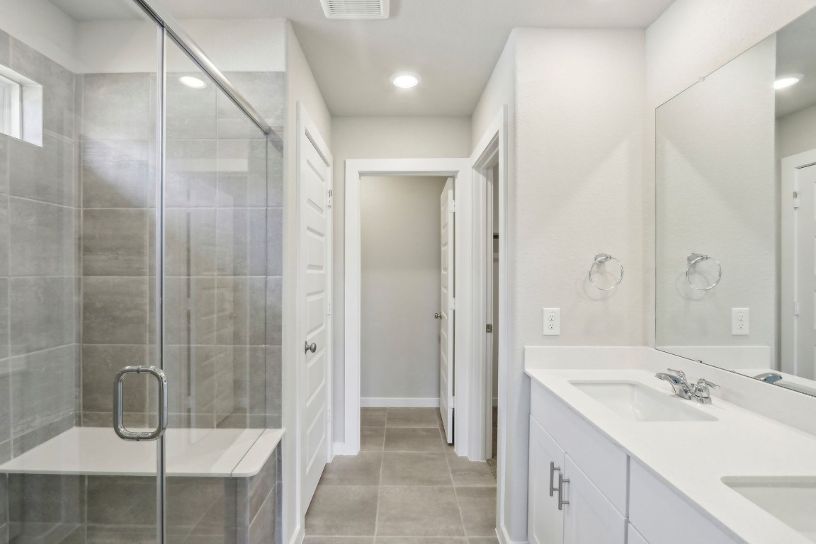 14174 Granger Pointe Lane Conroe, TX 77302 - Photo 6 of 9 a bathroom with a shower sink and mirror