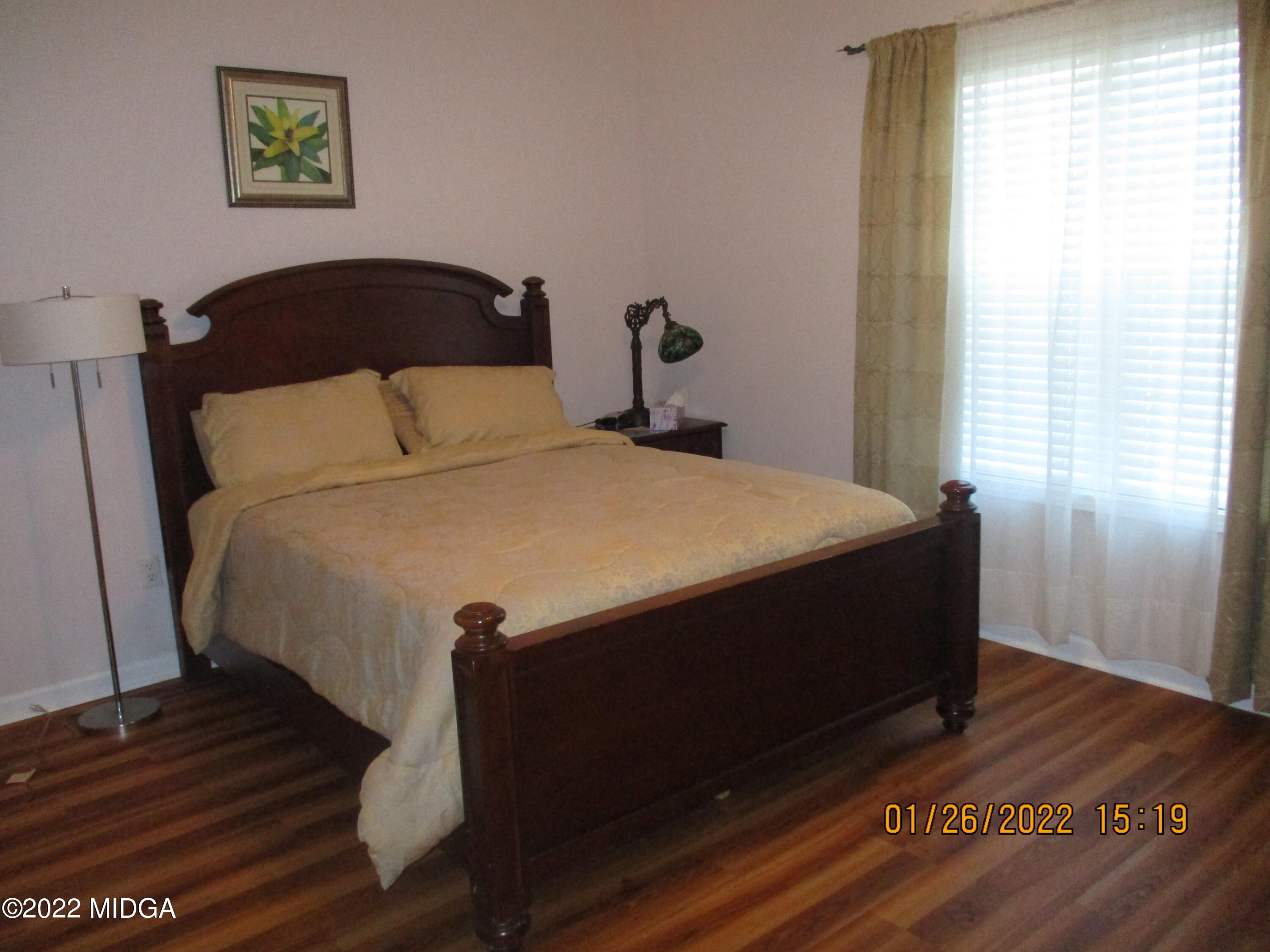 118 Joshua Street Perry, GA 31069 - Photo 12 of 24 a bed sitting in a bedroom next to a window