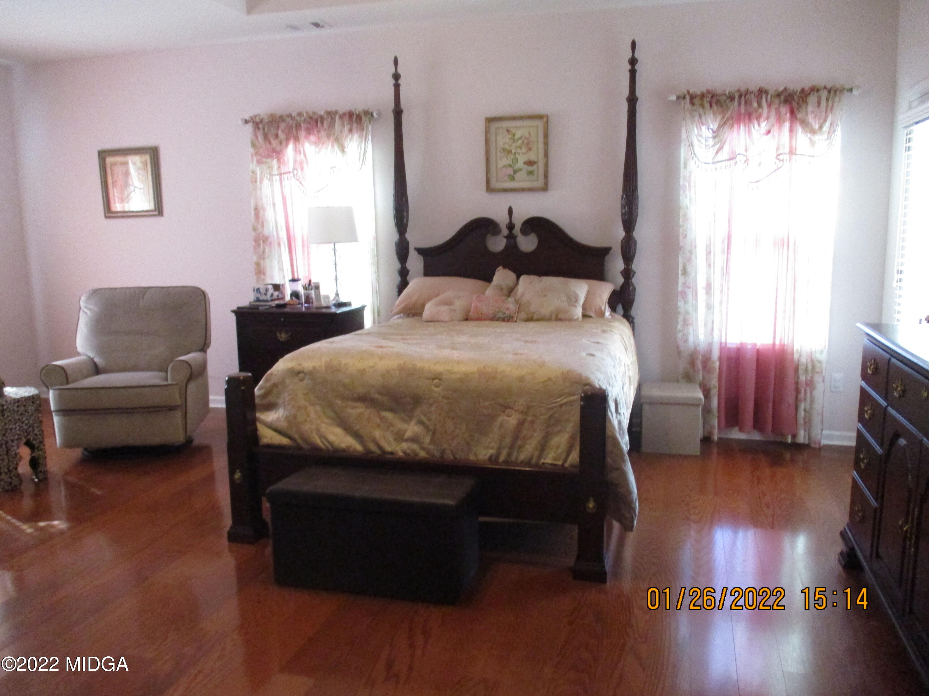 118 Joshua Street Perry, GA 31069 - Photo 8 of 24 a bedroom with a bed and wooden floor