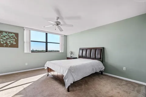 a bedroom with a bed and glass door