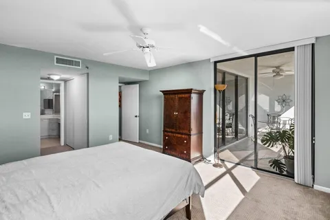 a bedroom with a bed and a large window