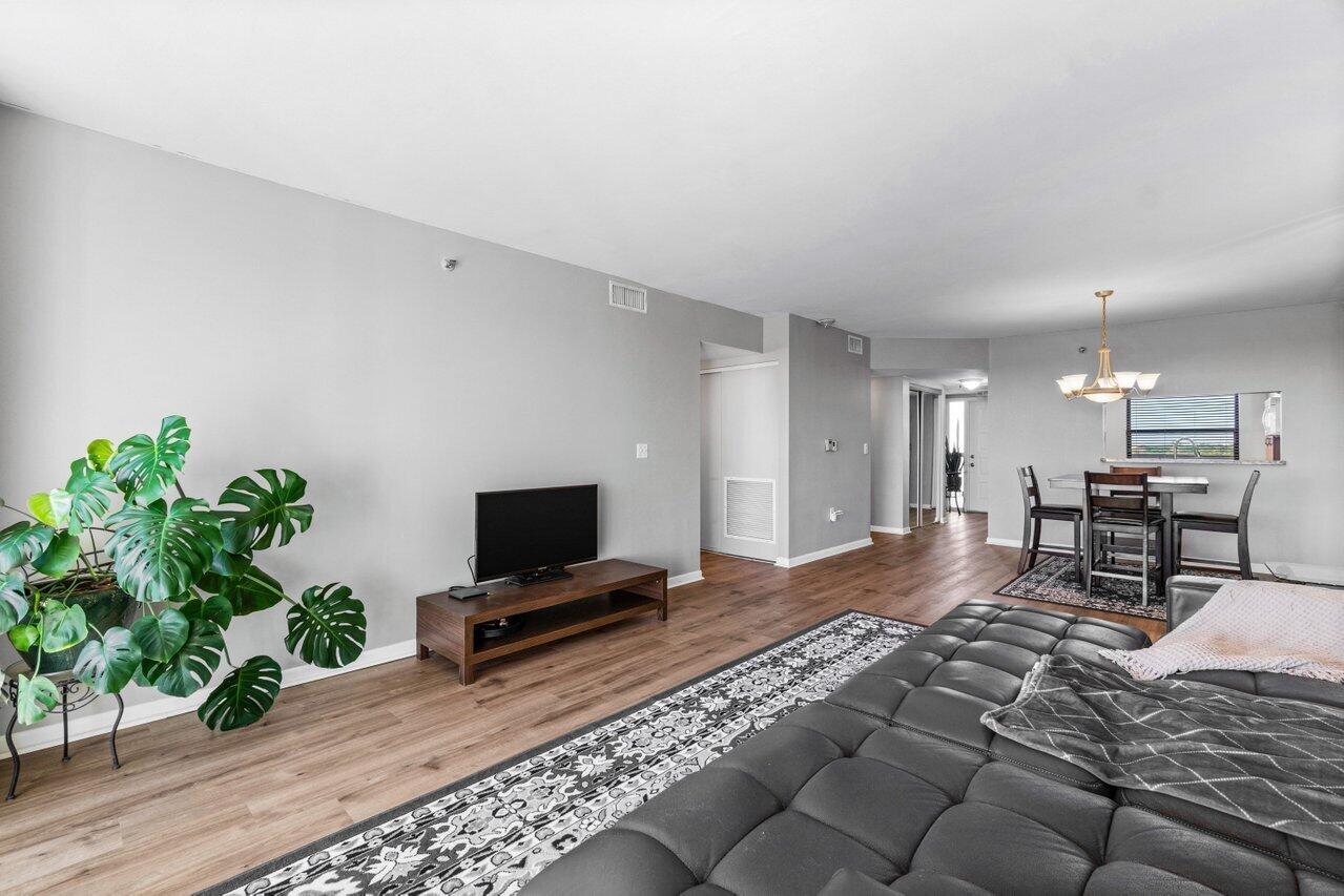 6530 Boca Del Mar Drive, Unit 735 Boca Raton, FL 33433 - Photo 10 of 38 a living room with furniture and a flat screen tv