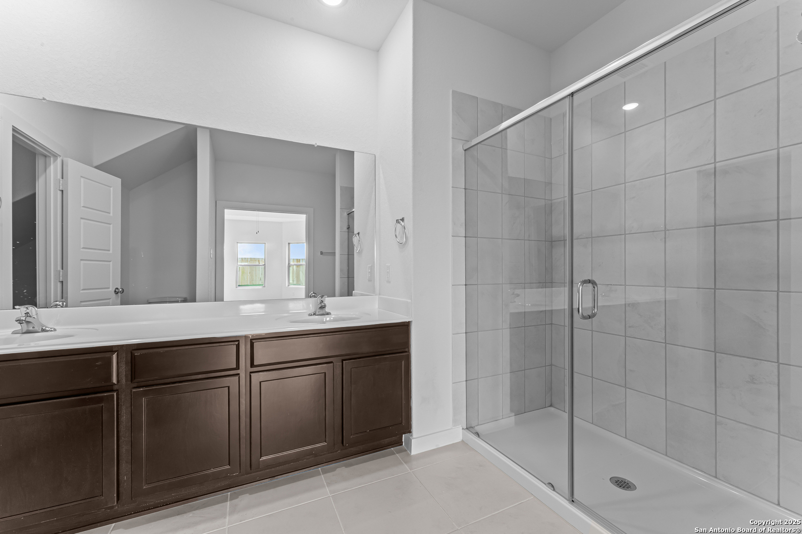 3022 Selhurst Street Converse, TX 78109 - Photo 15 of 32 a bathroom with a shower sink and mirror