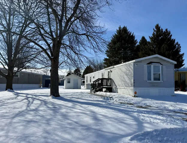 a view of a house with a yard covered in snow