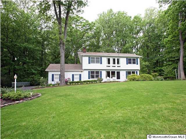 41 Tall Tree Road Middletown, NJ 07748 - Photo 1 of 3 a view of a house with a big yard and large trees