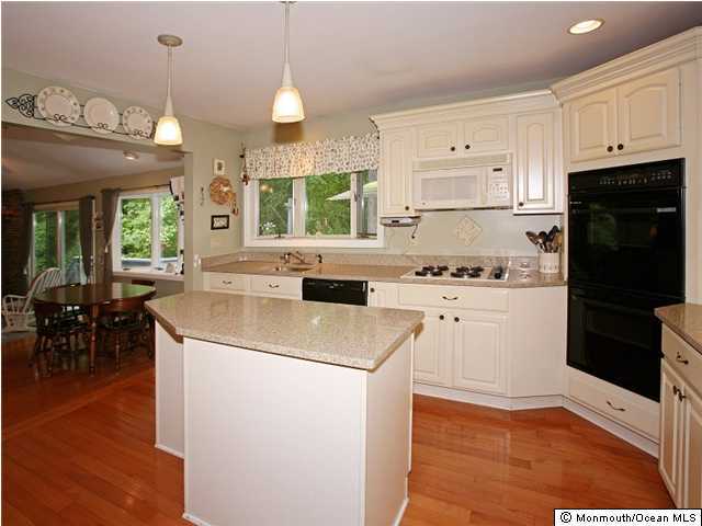 41 Tall Tree Road Middletown, NJ 07748 - Photo 3 of 3 a kitchen with a sink a stove a refrigerator and cabinets