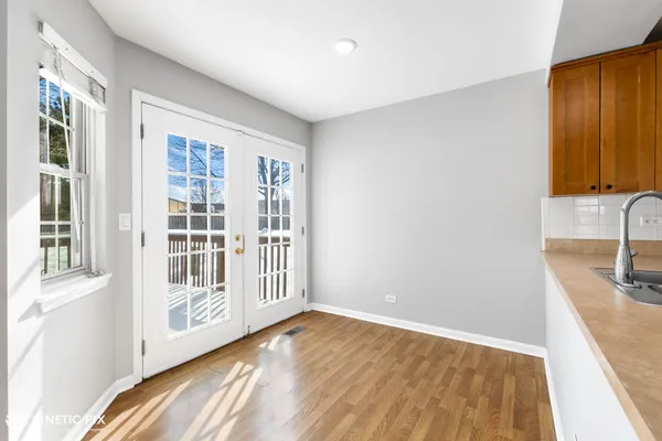 a view of a hallway with wooden floor and entryway