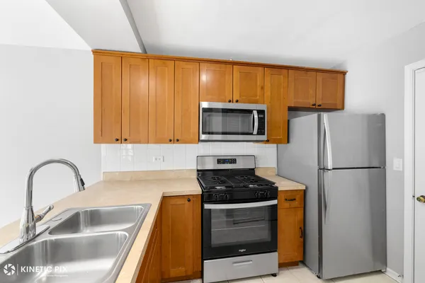 a kitchen with a refrigerator sink and microwave
