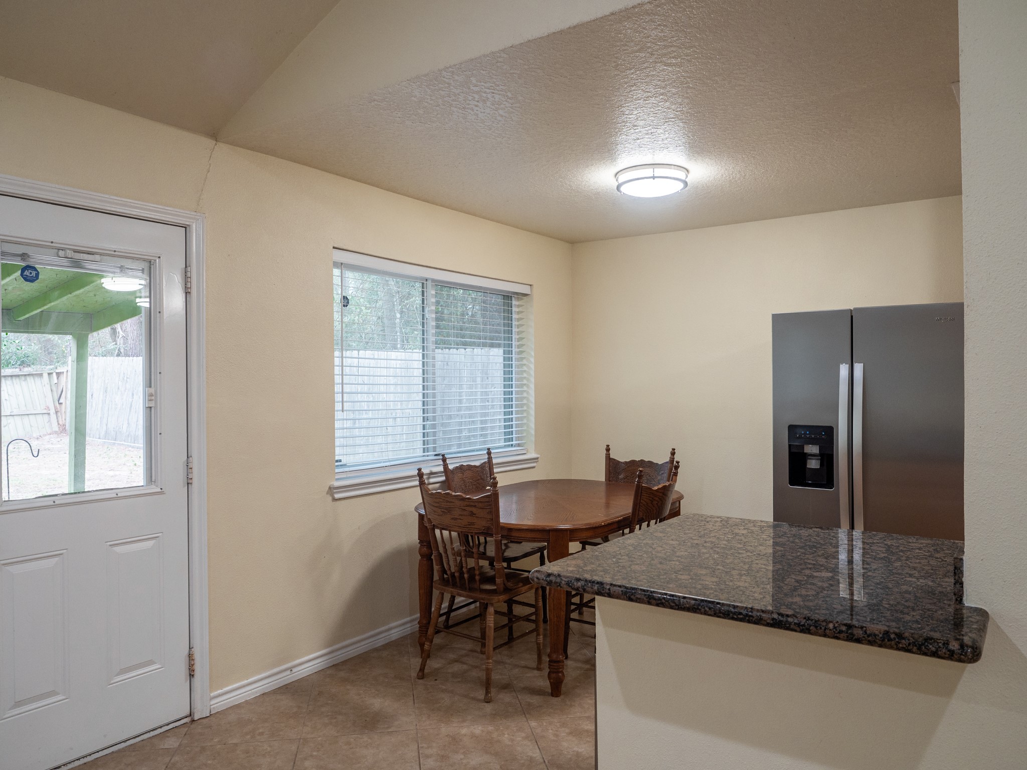 3302 Willie Way Spring, TX 77380 - Photo 13 of 28 a dining hall with stainless steel appliances granite countertop a dining table and chairs