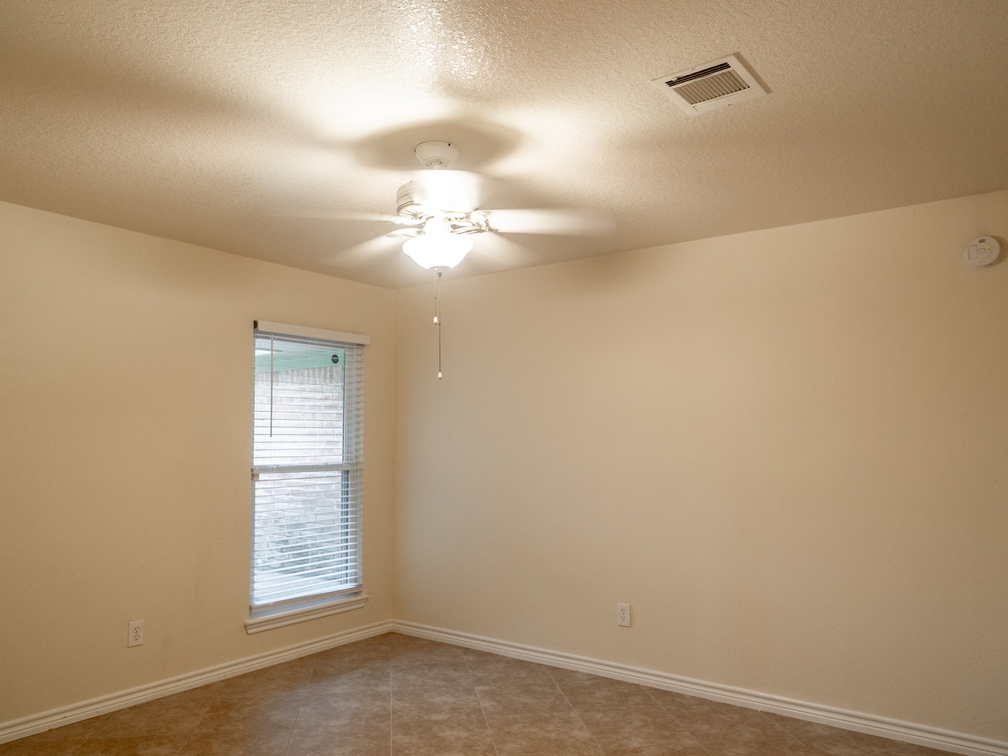 3302 Willie Way Spring, TX 77380 - Photo 16 of 28 an empty room with a chandelier fan and windows