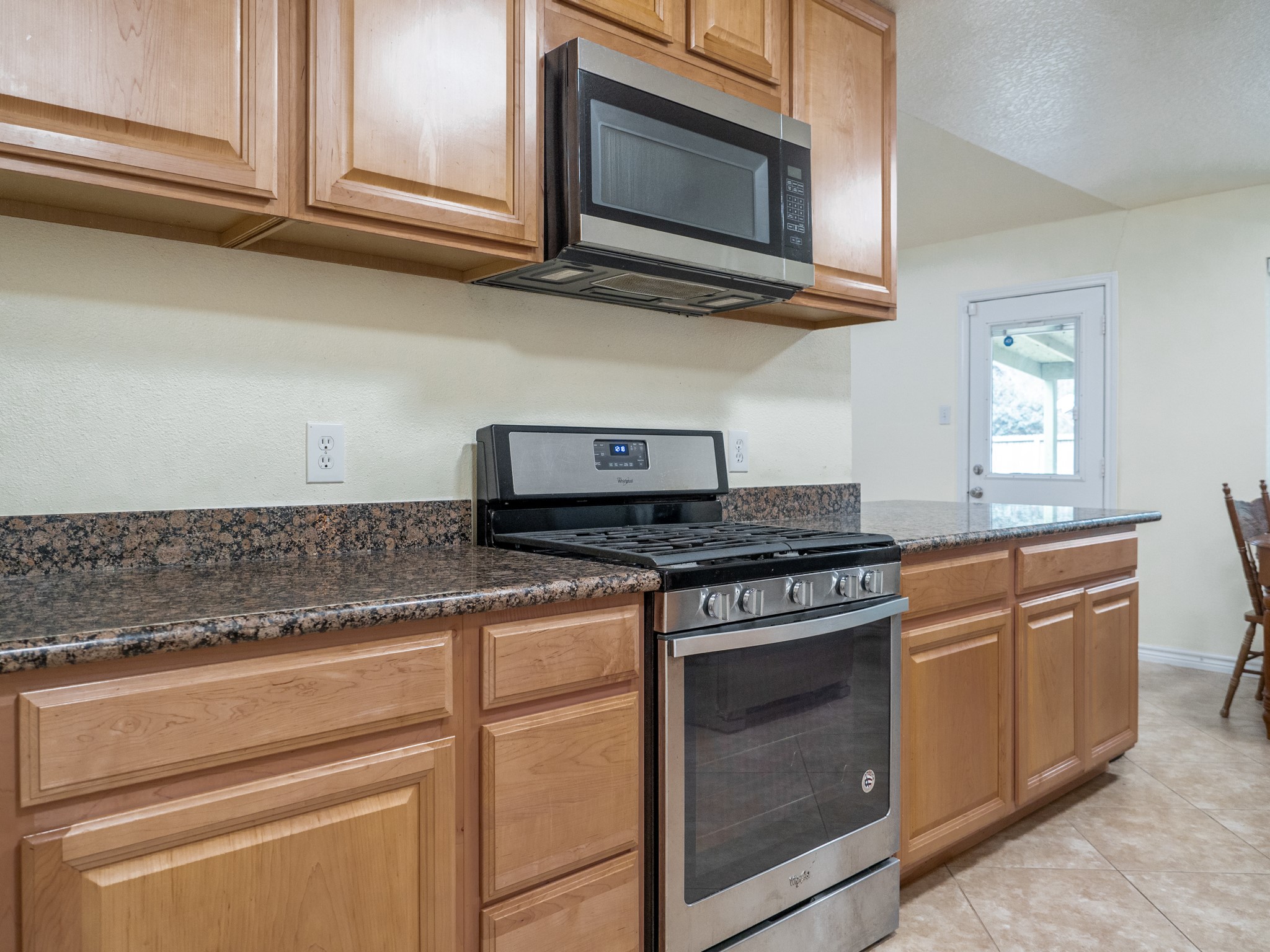 3302 Willie Way Spring, TX 77380 - Photo 4 of 28 a kitchen with stainless steel appliances granite countertop white cabinets and a stove top oven