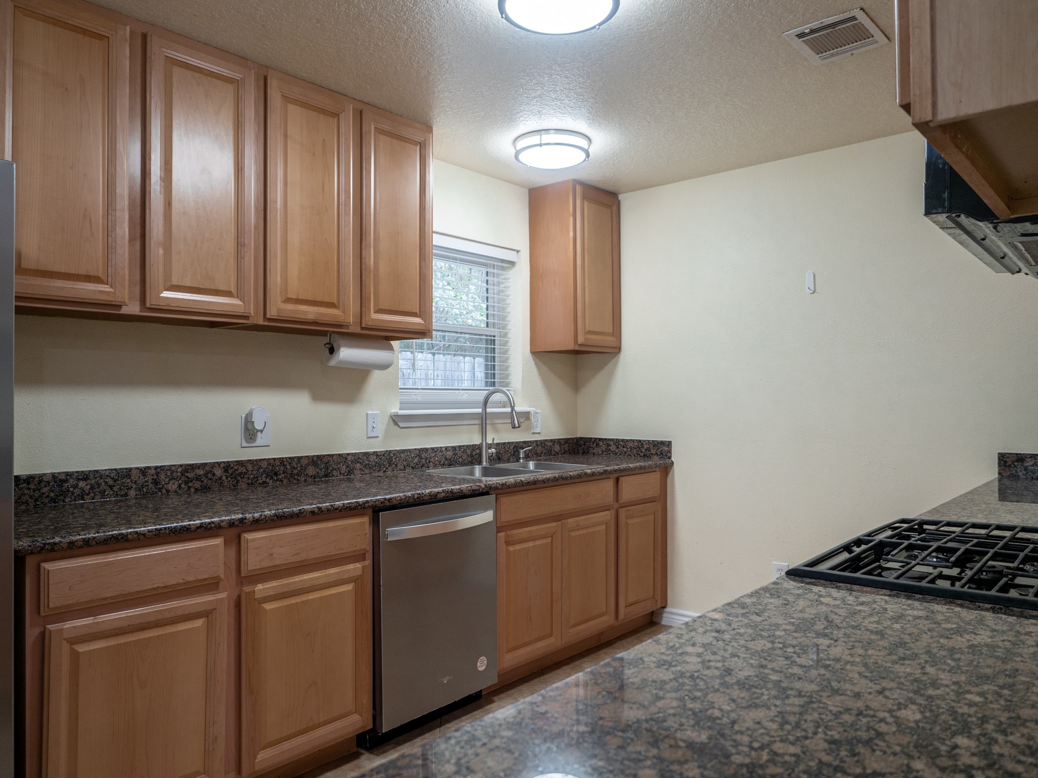3302 Willie Way Spring, TX 77380 - Photo 8 of 28 a kitchen with granite countertop a sink stainless steel appliances and cabinets