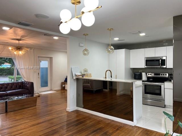 200 Northeast 48th Terrace Miami, FL 33137 - Photo 13 of 20 a kitchen with stainless steel appliances granite countertop a stove a sink and a microwave