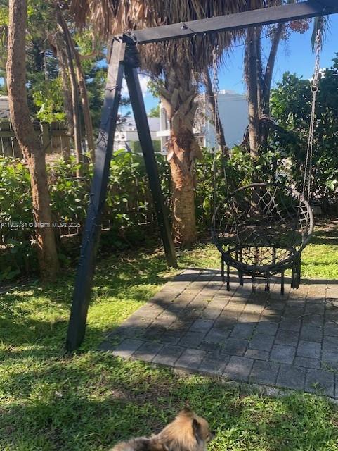 200 Northeast 48th Terrace Miami, FL 33137 - Photo 18 of 20 a view of a yard with plants and a bench