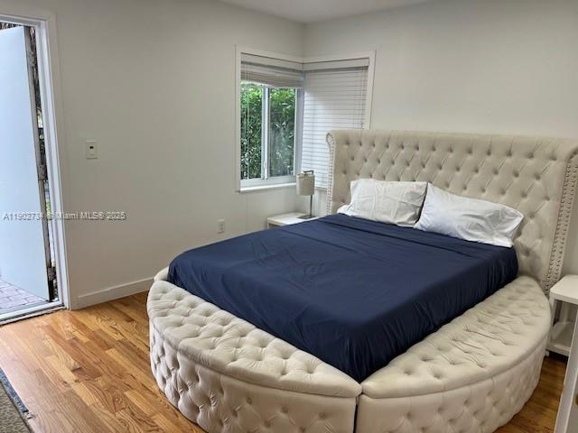 200 Northeast 48th Terrace Miami, FL 33137 - Photo 5 of 20 a bed sitting in a bedroom next to a window