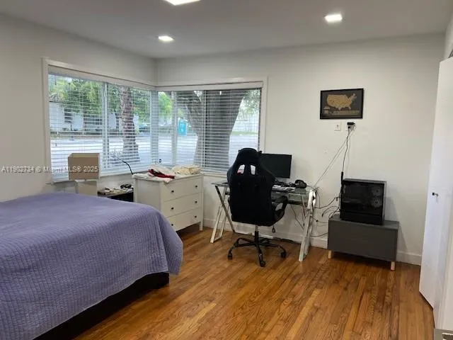 a bed room with a bed and a chair