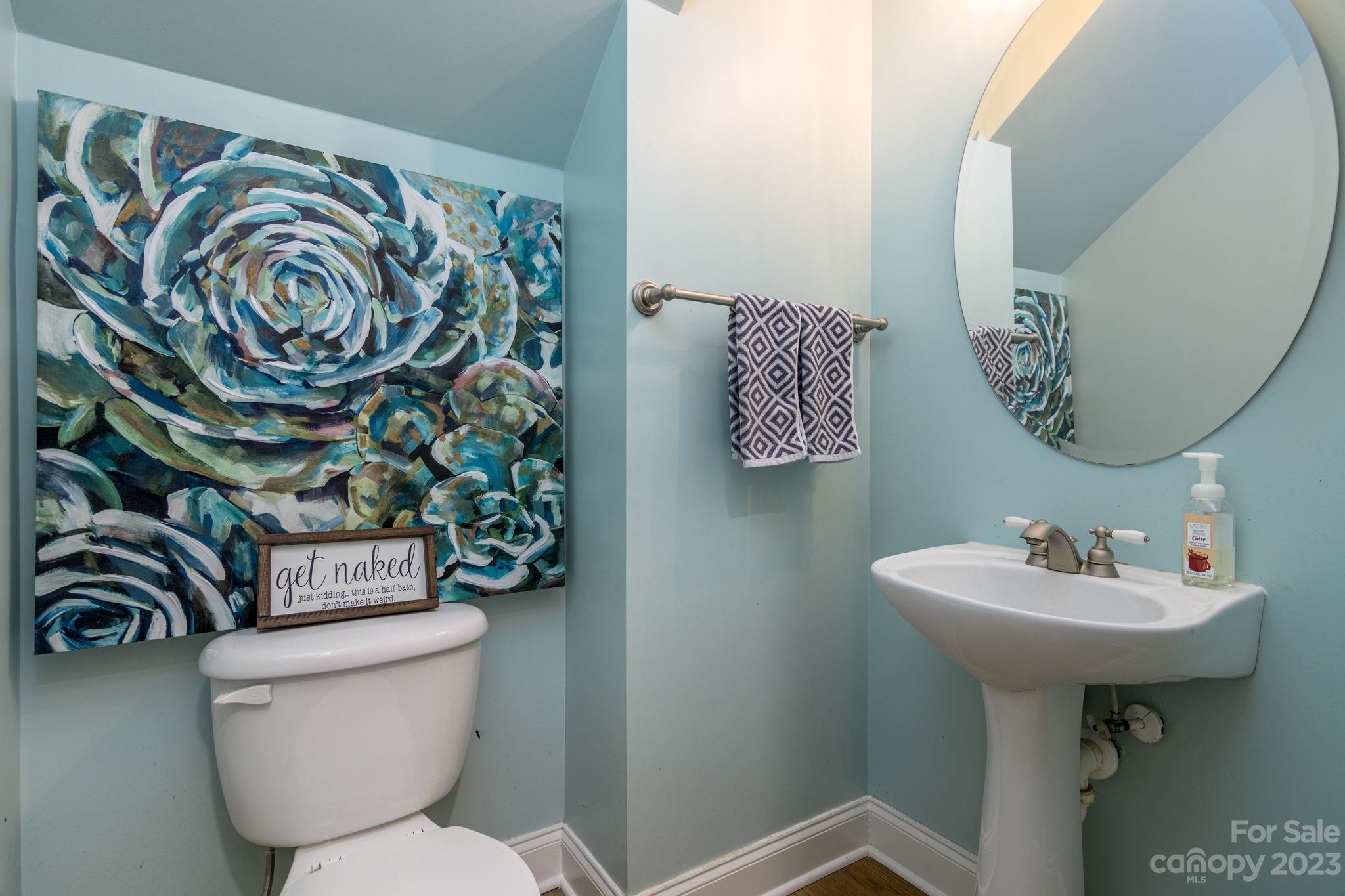 882 Promenade Walk Fort Mill, SC 29708 - Photo 13 of 48 a bathroom with a toilet sink and mirror