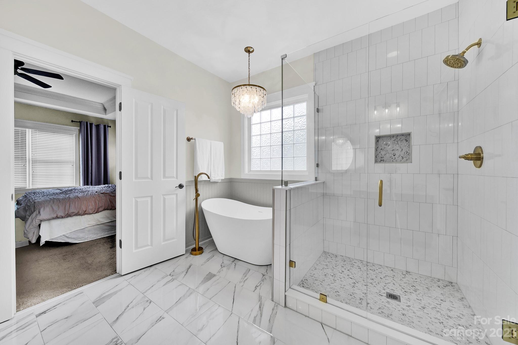882 Promenade Walk Fort Mill, SC 29708 - Photo 18 of 48 a bathroom with a tub shower and mirror