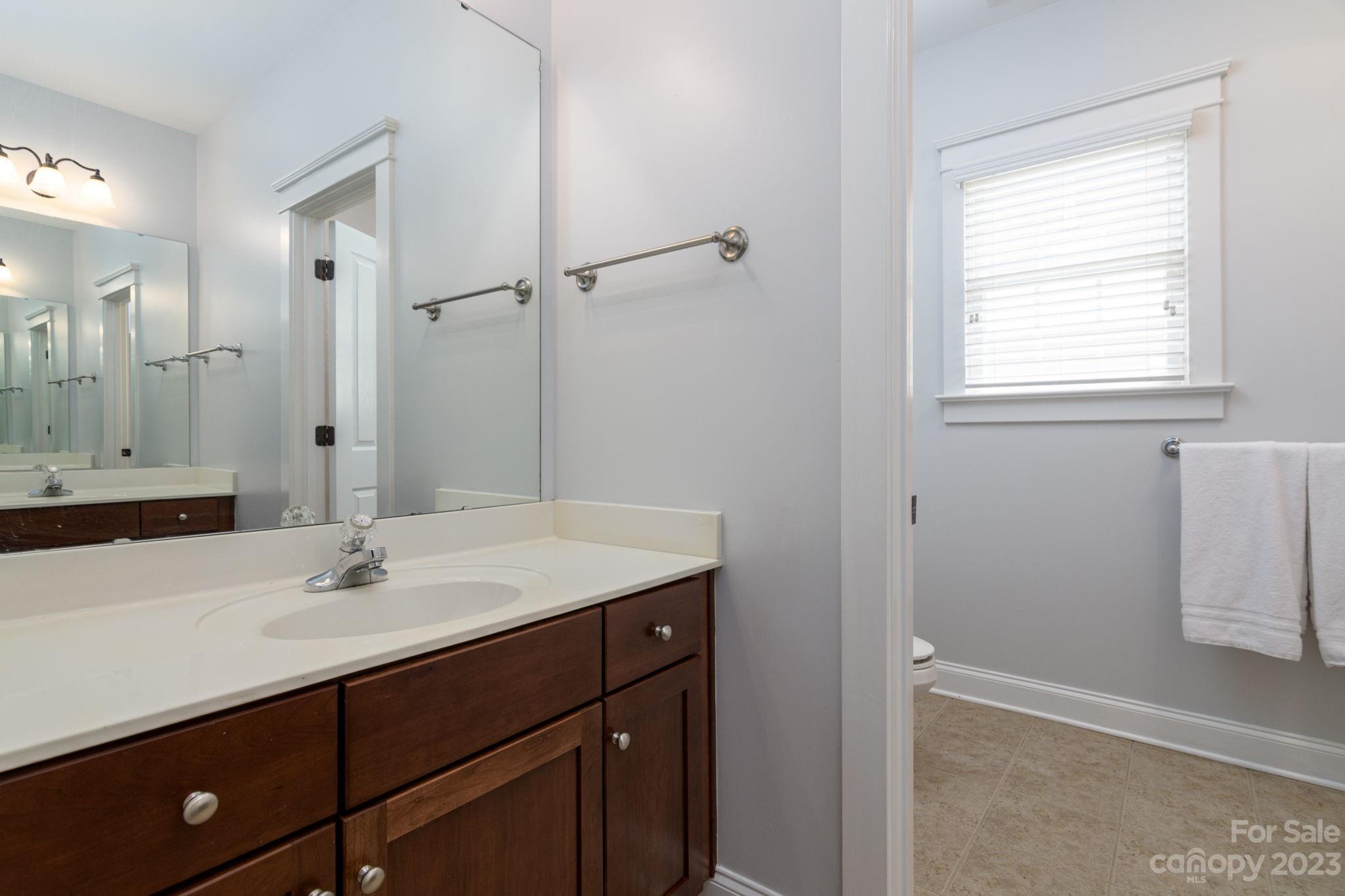 882 Promenade Walk Fort Mill, SC 29708 - Photo 20 of 48 a bathroom with a sink vanity granite tub and shower