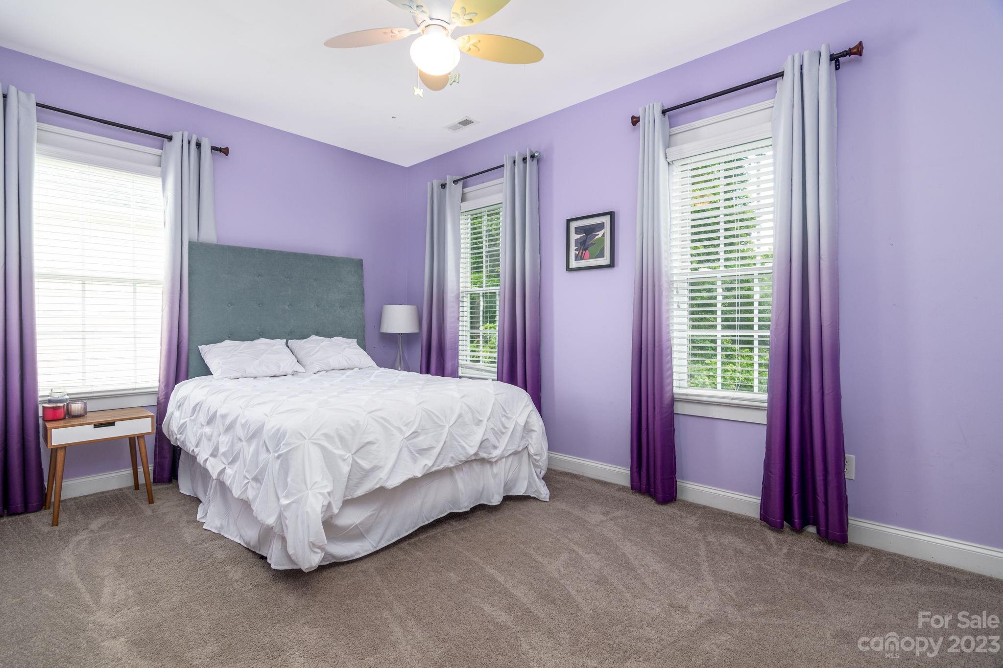 882 Promenade Walk Fort Mill, SC 29708 - Photo 22 of 48 a spacious bedroom with a bed and a chandelier