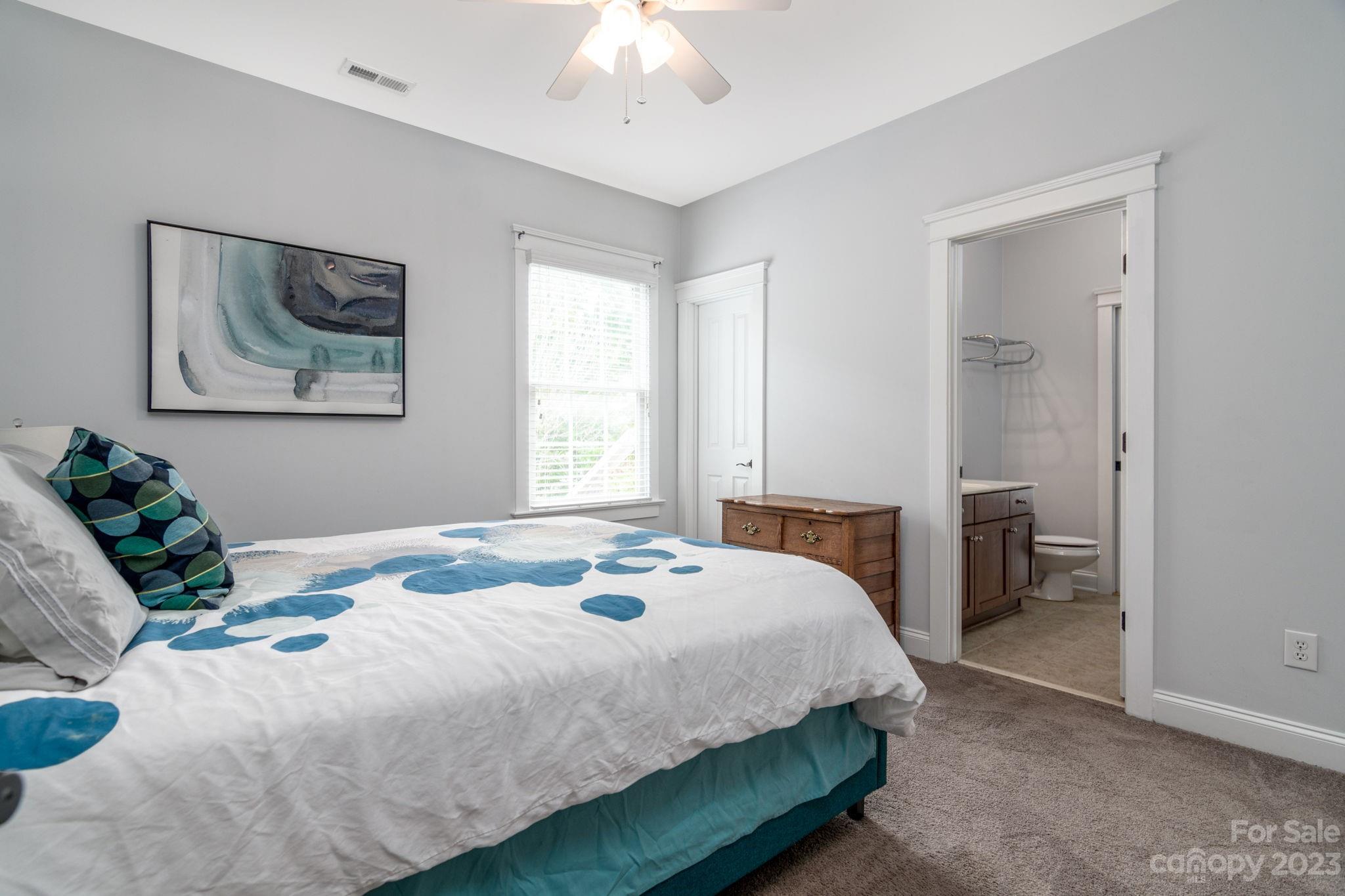 882 Promenade Walk Fort Mill, SC 29708 - Photo 23 of 48 a bedroom with a bed and a painting on the wall
