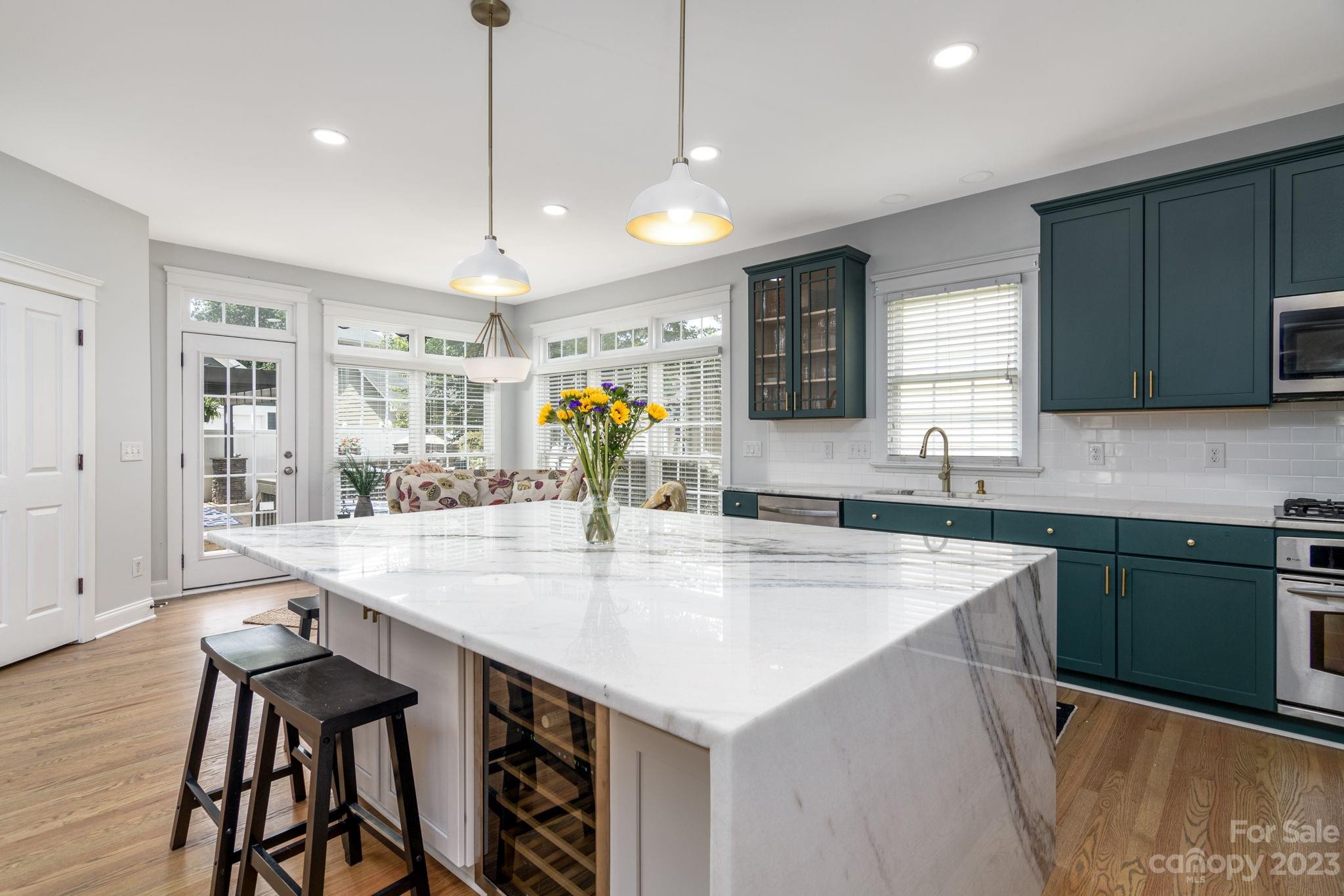 882 Promenade Walk Fort Mill, SC 29708 - Photo 8 of 48 a kitchen with stainless steel appliances granite countertop a sink a stove and a wooden floors
