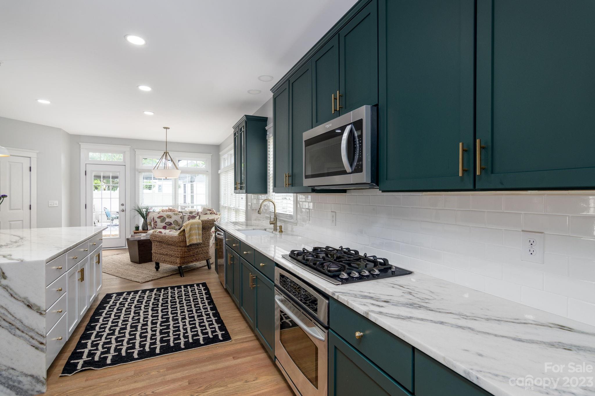 882 Promenade Walk Fort Mill, SC 29708 - Photo 9 of 48 a kitchen with a stove a sink and a microwave