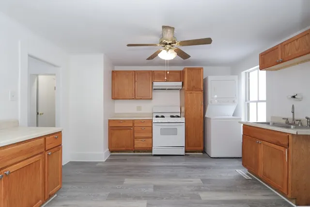 a kitchen with stainless steel appliances a stove a sink and a refrigerator