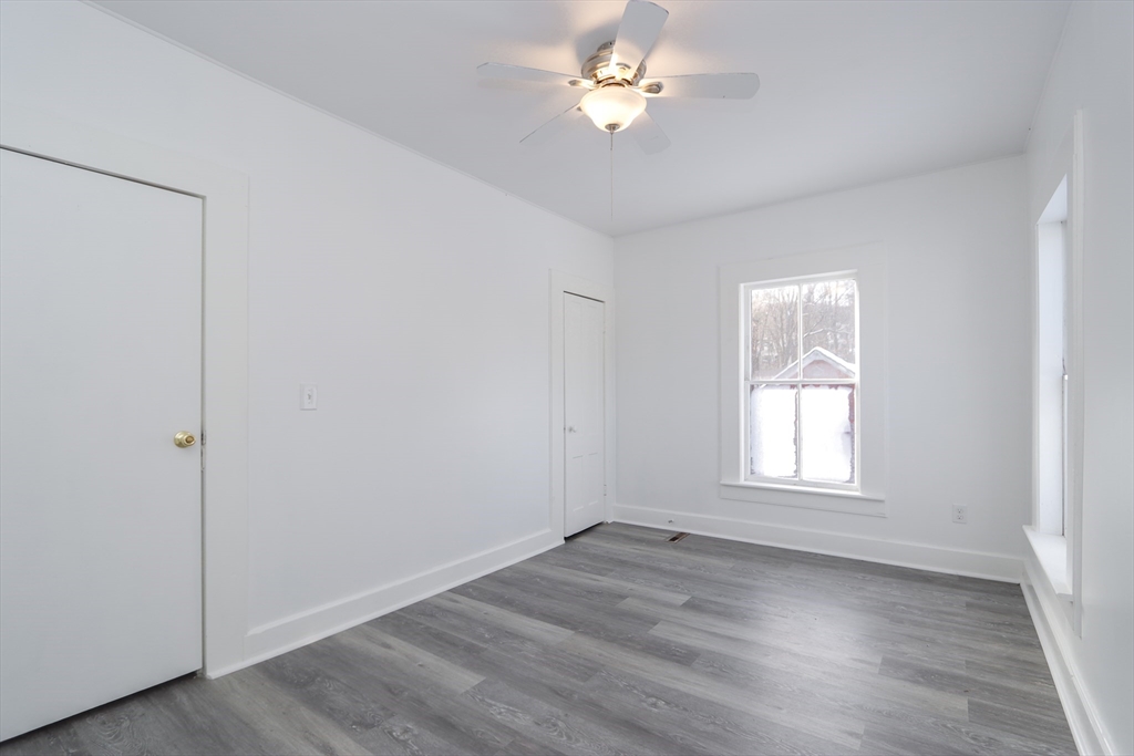 56 Middlefield Road Chester, MA 01011 - Photo 16 of 38 a view of empty room with wooden floor and fan