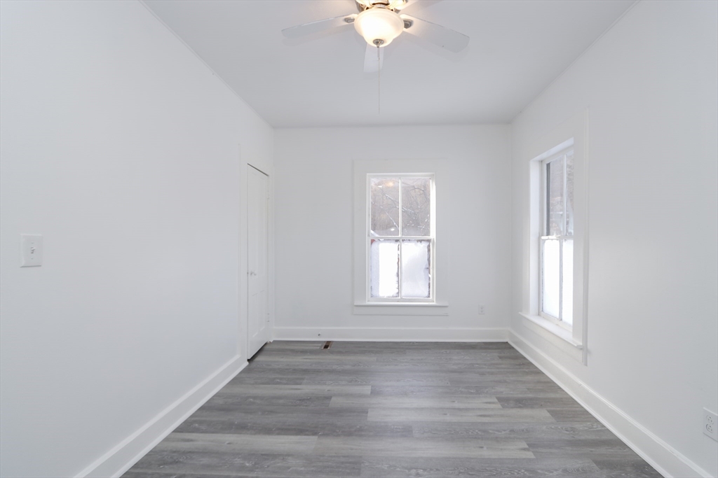 56 Middlefield Road Chester, MA 01011 - Photo 17 of 38 an empty room with wooden floor and windows