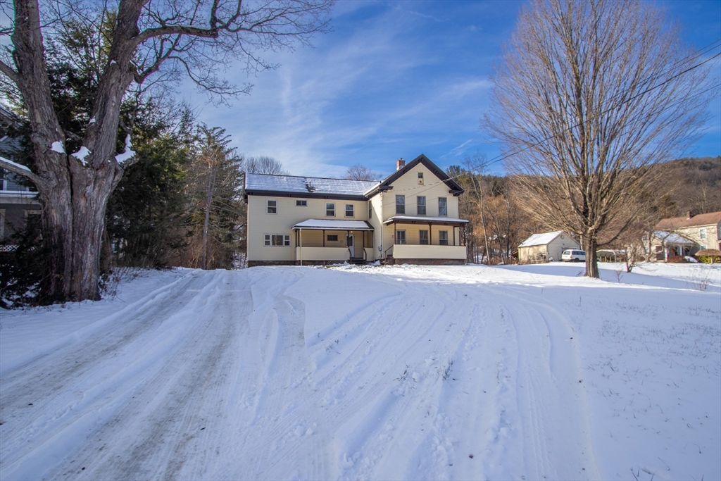 56 Middlefield Road Chester, MA 01011 - Photo 2 of 38 a view of a house with a yard covered in snow