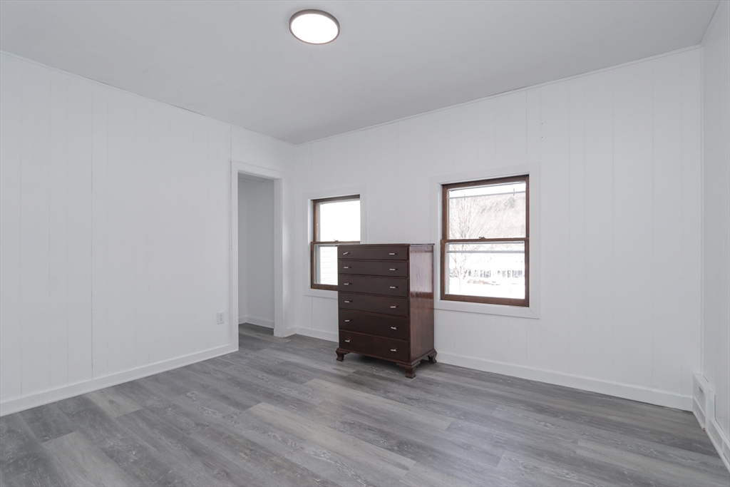 56 Middlefield Road Chester, MA 01011 - Photo 21 of 38 an empty room with wooden floor cabinet and windows