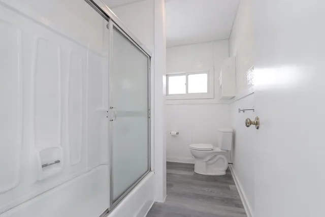 a bathroom with a toilet and a shower