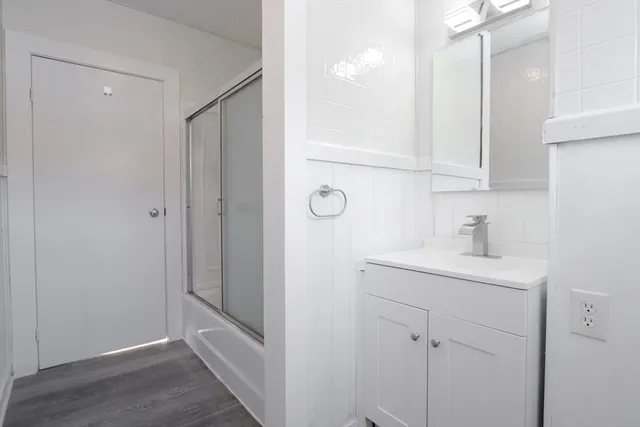a bathroom with a granite countertop sink a mirror and vanity