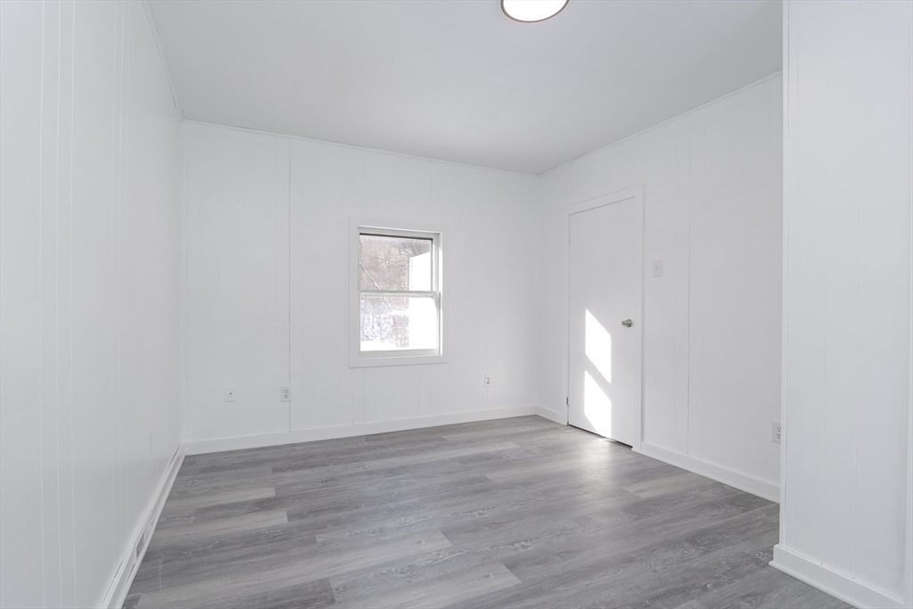 56 Middlefield Road Chester, MA 01011 - Photo 25 of 38 an empty room with wooden floor and windows