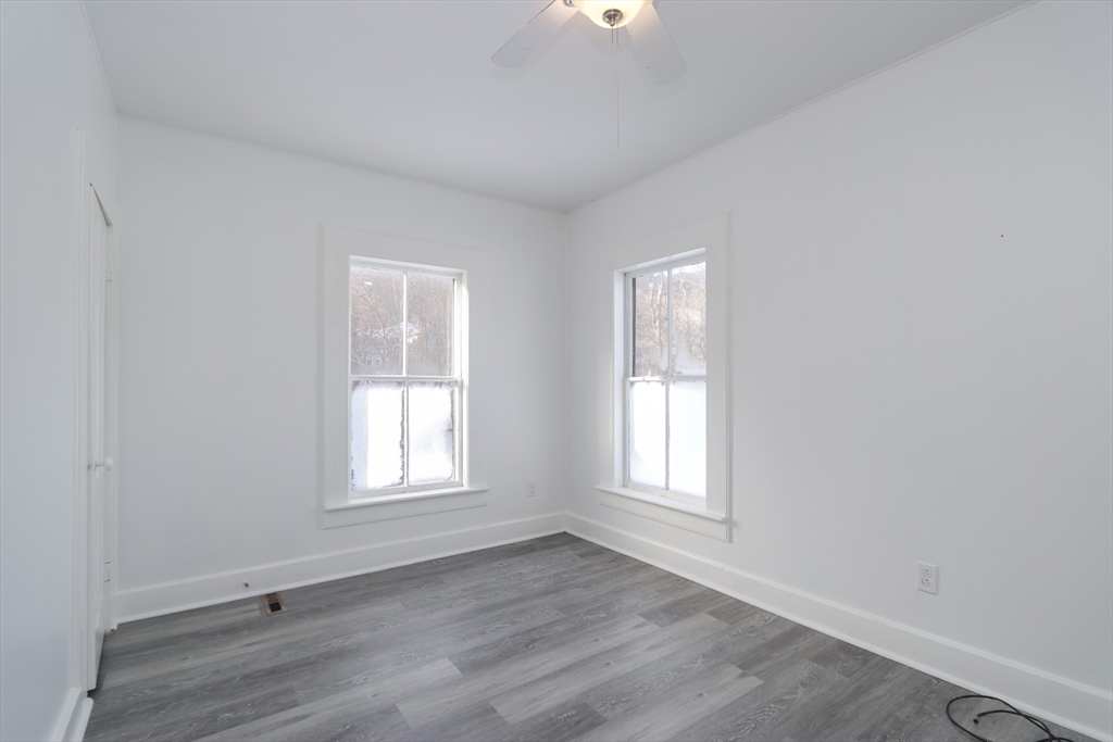 56 Middlefield Road Chester, MA 01011 - Photo 33 of 38 an empty room with wooden floor and windows