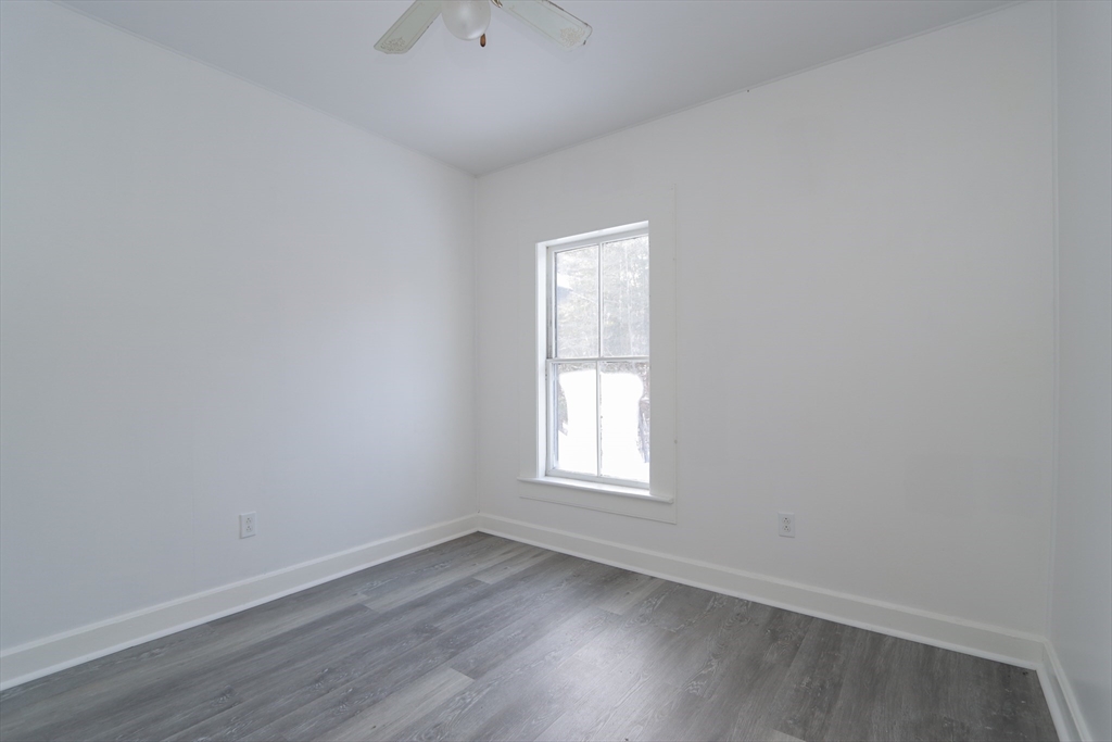 56 Middlefield Road Chester, MA 01011 - Photo 36 of 38 an empty room with wooden floor and windows
