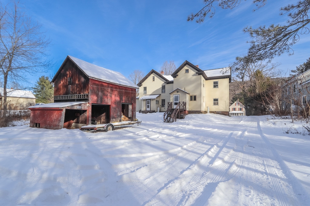 56 Middlefield Road Chester, MA 01011 - Photo 7 of 38 a view of house with a yard and covered with snow