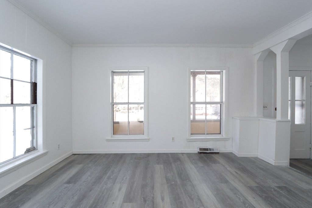 56 Middlefield Road Chester, MA 01011 - Photo 10 of 38 an empty room with wooden floor and windows