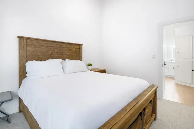 a bedroom with a bed and a table