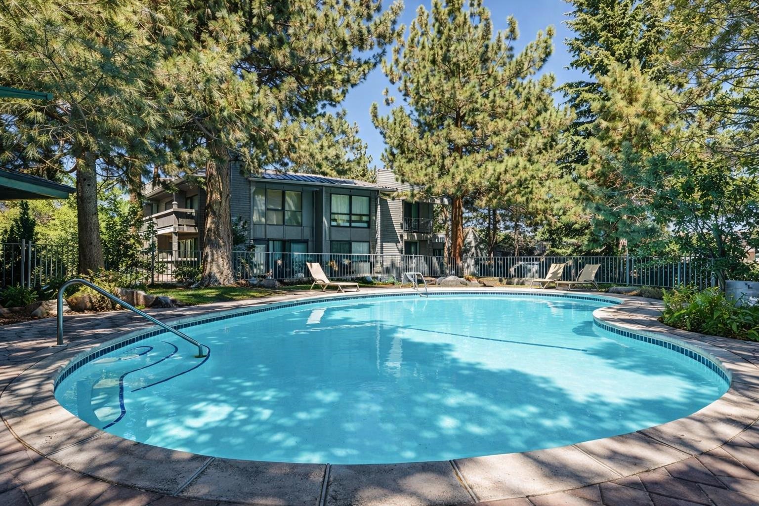 286 Old Mammoth Road, Unit 19 Mammoth Lakes, CA 93546 - Photo 16 of 19 a view of swimming pool with outdoor seating and trees in the background