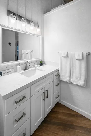 a bathroom with a double vanity sink and mirror