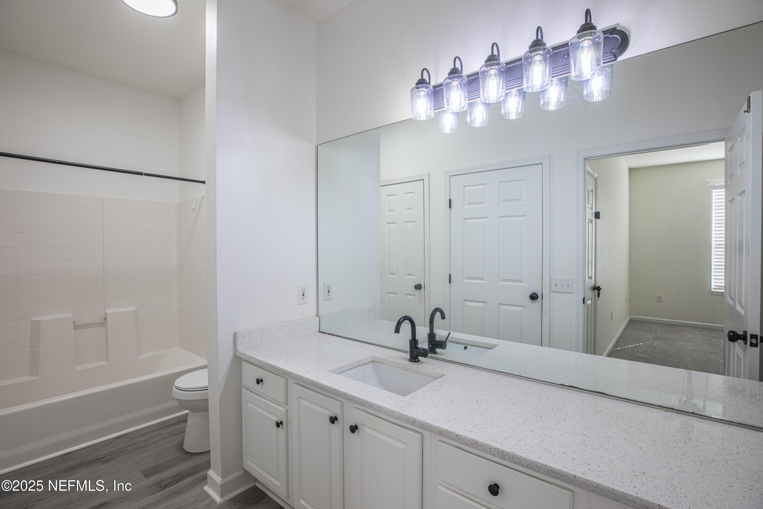 7990 Baymeadows Road, Unit 625 Jacksonville, FL 32256 - Photo 12 of 25 a bathroom with a sink a toilet and a large mirror