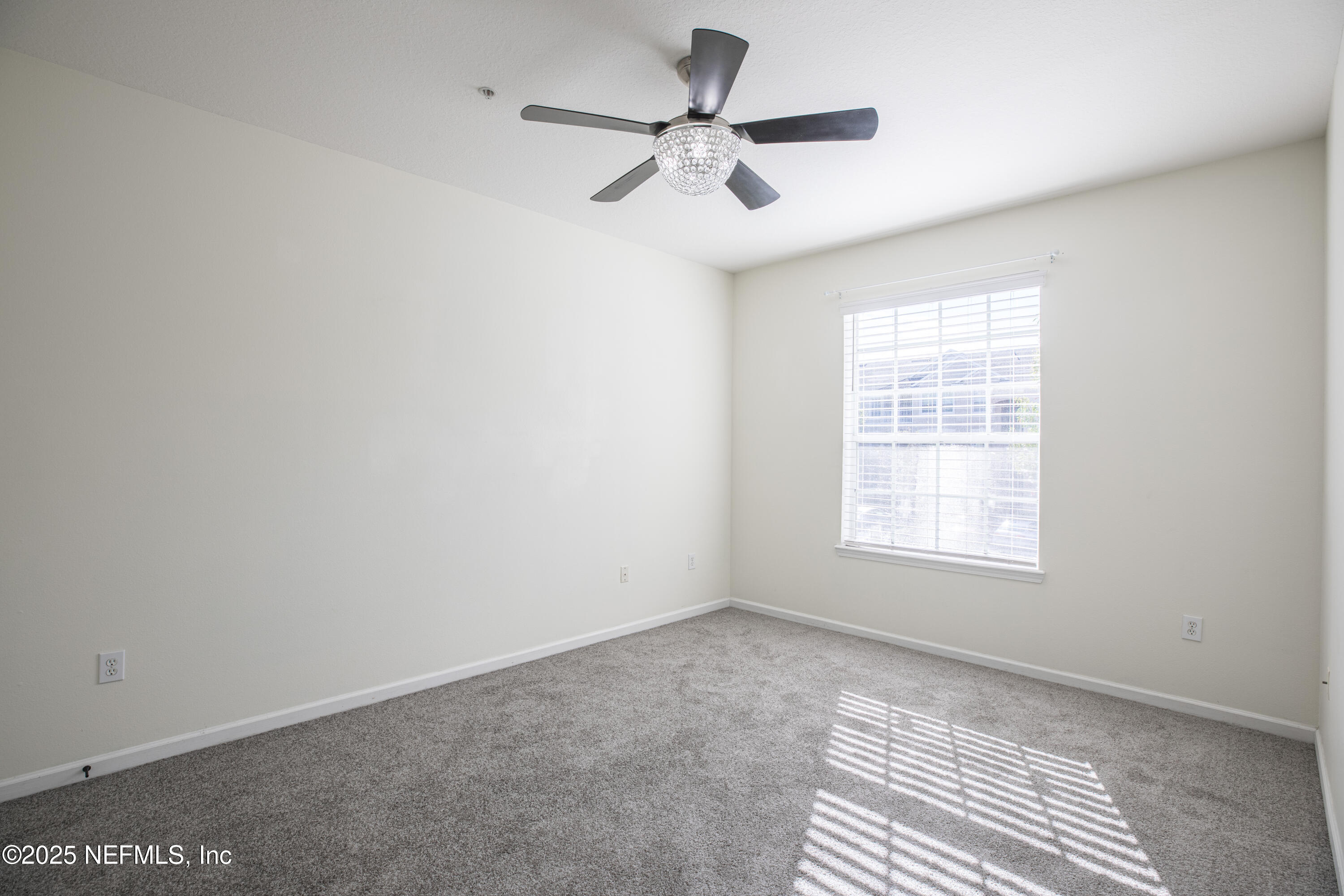 7990 Baymeadows Road, Unit 625 Jacksonville, FL 32256 - Photo 14 of 25 an empty room with a window and a fan