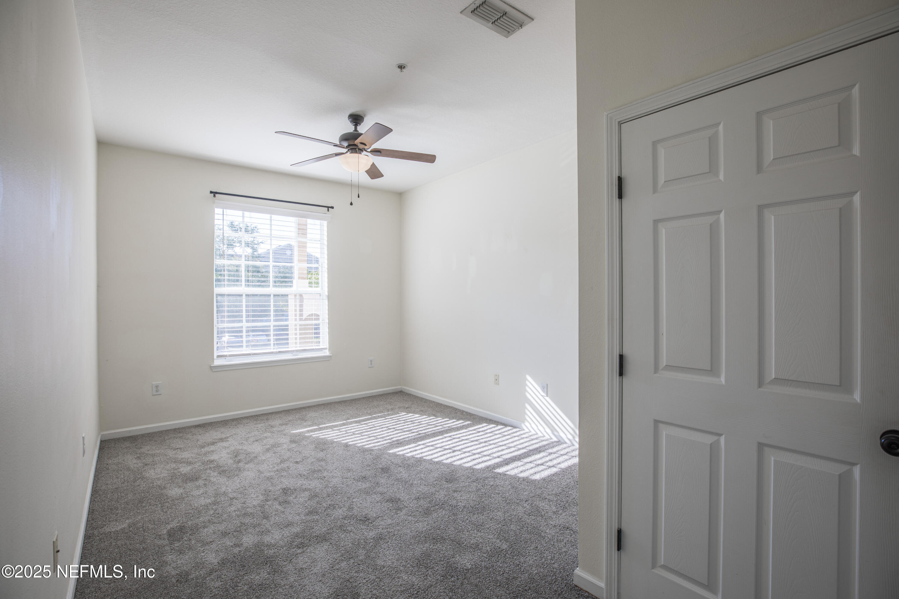 7990 Baymeadows Road, Unit 625 Jacksonville, FL 32256 - Photo 18 of 25 an empty room with windows and fan
