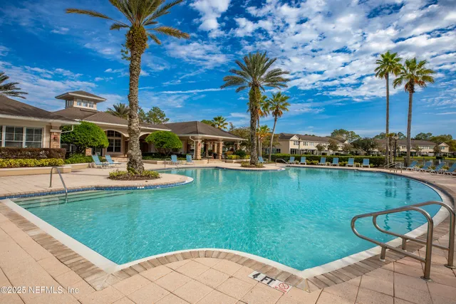 a swimming pool with outdoor seating and yard