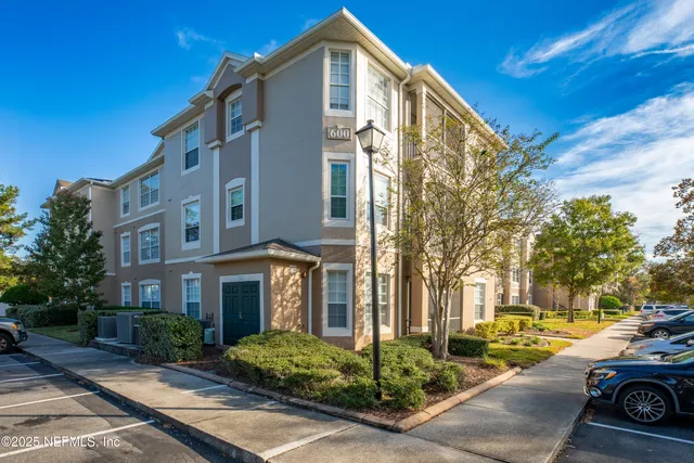 a front view of a residential apartment building with a yard