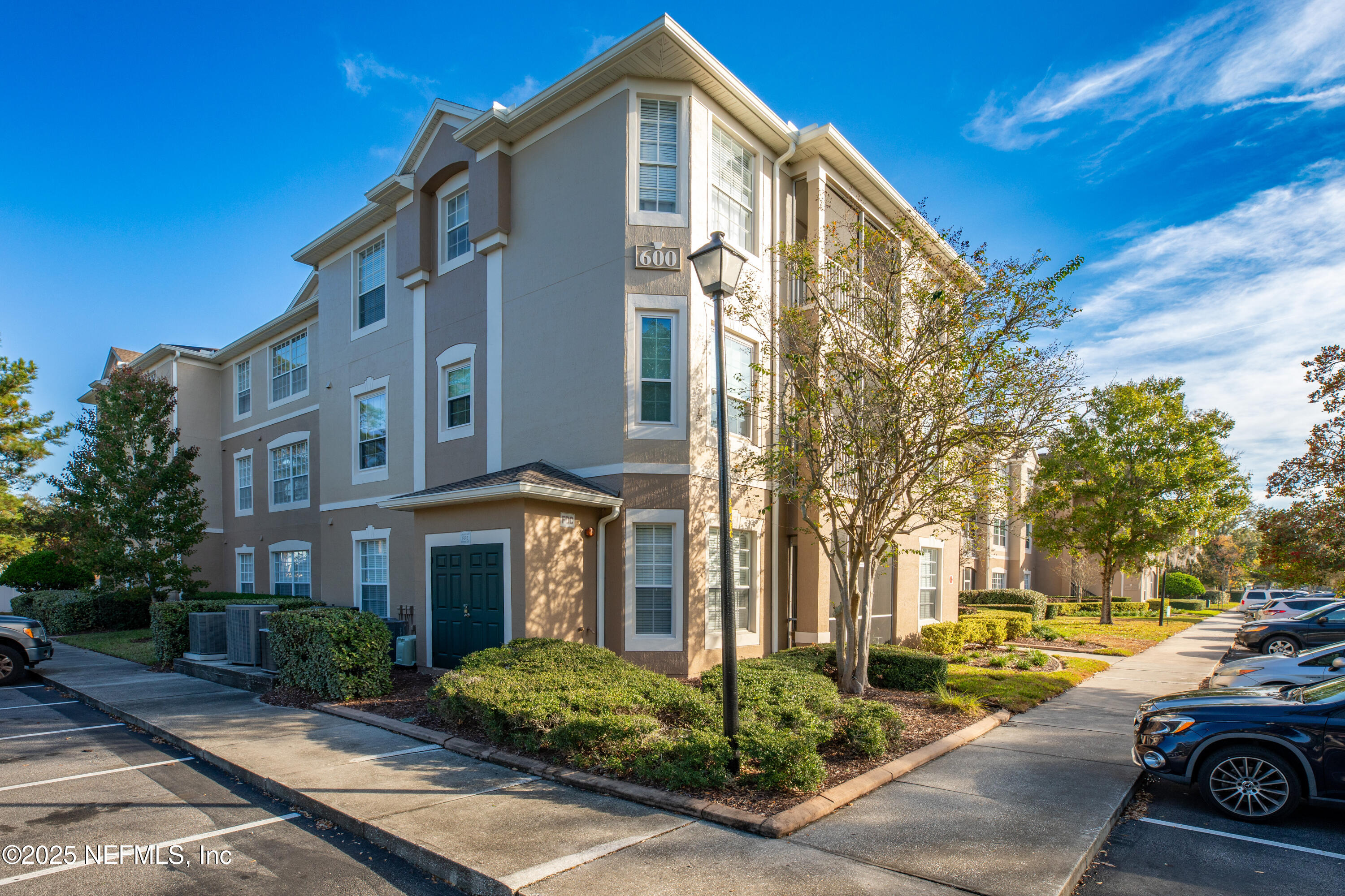 7990 Baymeadows Road, Unit 625 Jacksonville, FL 32256 - Photo 23 of 25 a front view of a residential apartment building with a yard