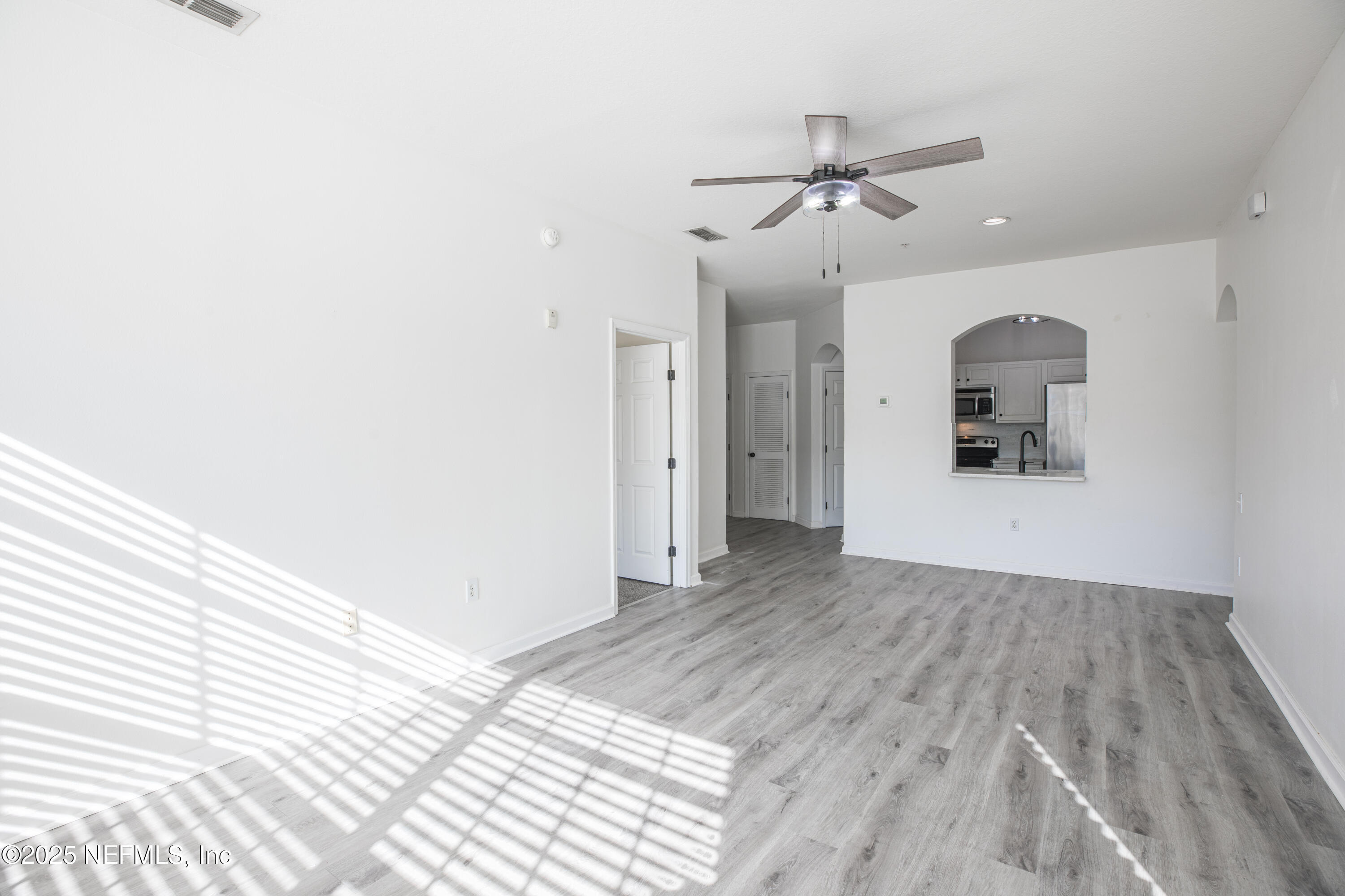 7990 Baymeadows Road, Unit 625 Jacksonville, FL 32256 - Photo 5 of 25 an empty room with wooden floor and windows